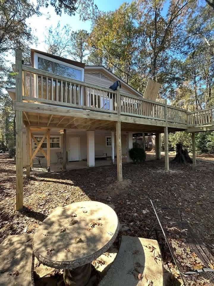 Elevated wooden deck with framing visible beneath it