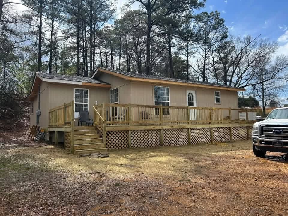 Front wooden deck with lattice skirting and stairs