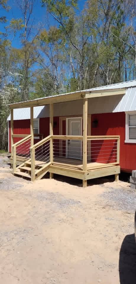 Covered porch with cable-rail infill and a metal roof