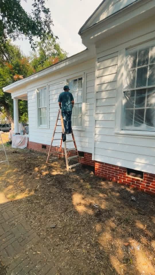 Exterior painting with surfaces masked for a clean finish